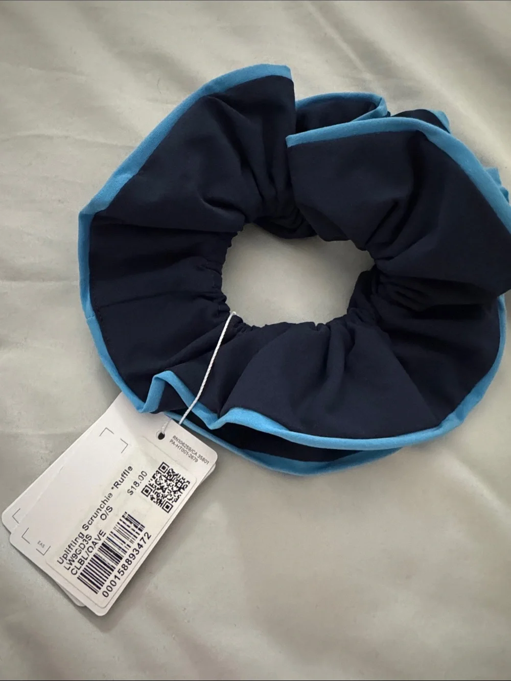 lululemon navy scrunchie with sky blue trim